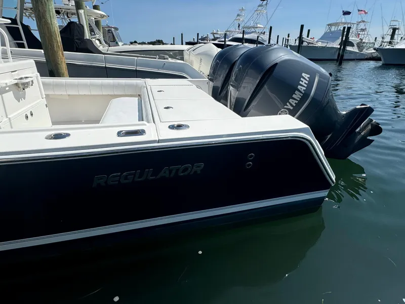 Slide: The Image of 2009 Regulator 32 Forward Seating boat docked with Yamaha engines. - 36