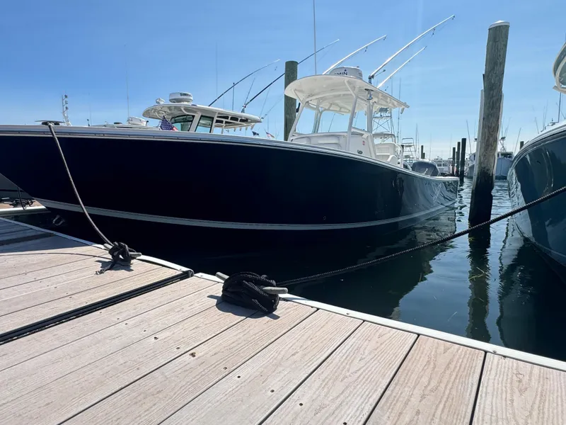 Slide: The Image of 2009 Regulator 32 Forward Seating boat docked at marina. - 37