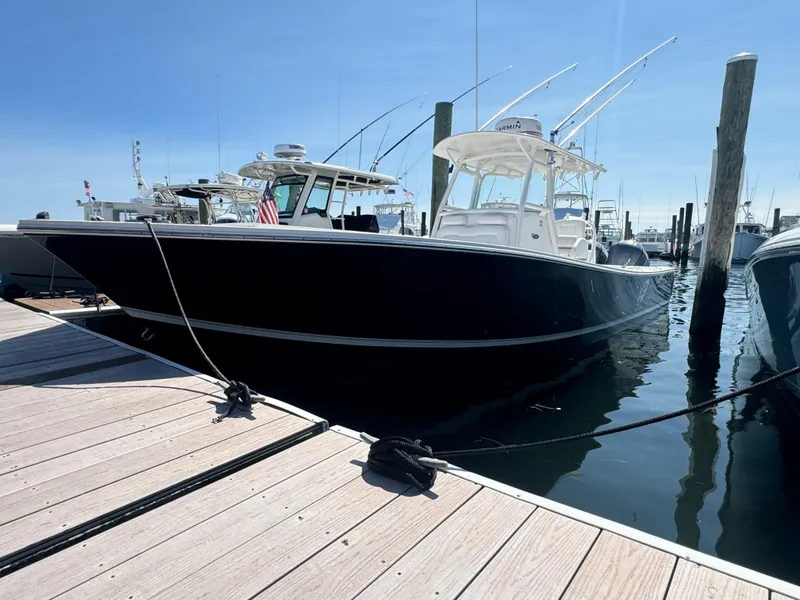 Slide: The Image of 2009 Regulator 32 Forward Seating boat docked at marina under clear sky. - 38