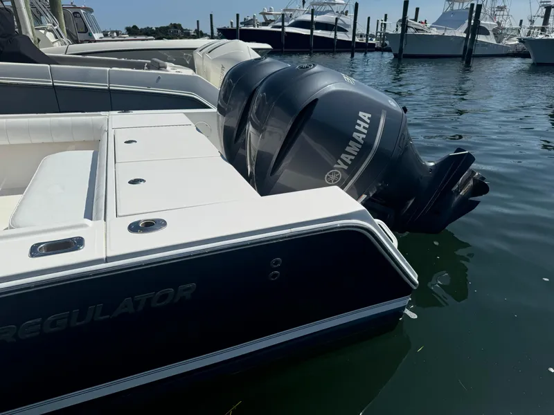 Slide: The Image of 2009 Regulator 32 Forward Seating boat with Yamaha engines docked in marina. - 4
