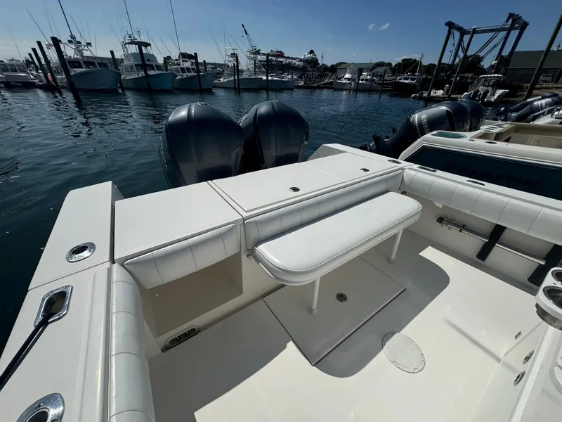 Slide: The Image of 2009 Regulator 32 Forward Seating boat at marina, featuring dual engines and spacious seating. - 42