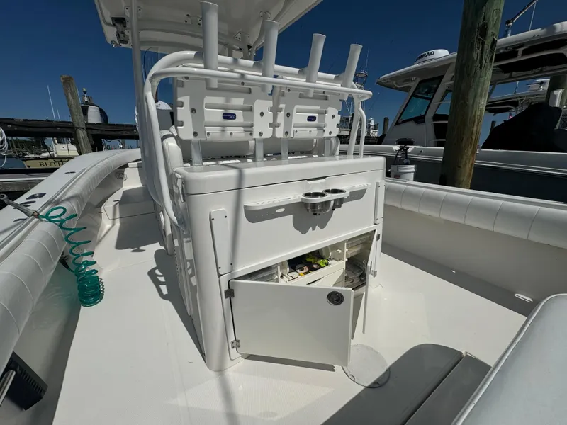Slide: The Image of 2009 Regulator 32 Forward Seating boat interior with storage and rod holders. - 43