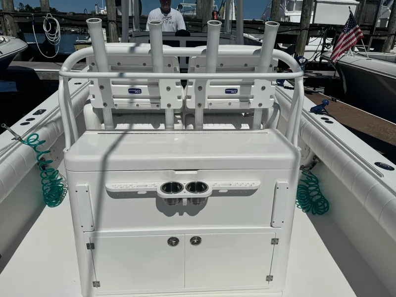 Slide: The Image of 2009 Regulator 32 Forward Seating boat with rod holders and storage, docked at marina. - 44