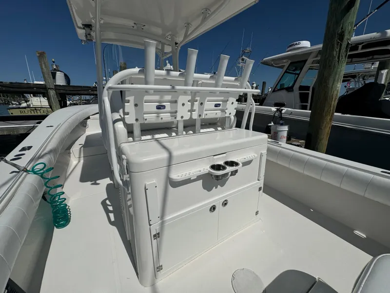 Slide: The Image of 2009 Regulator 32 Forward Seating boat interior with rod holders and storage. - 46