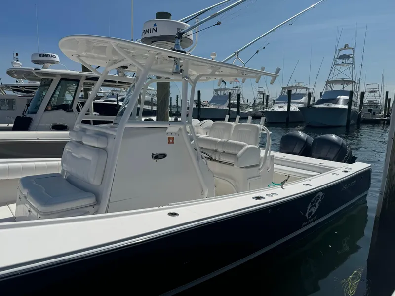 Slide: The Image of 2009 Regulator 32 Forward Seating boat docked in marina, featuring dual engines. - 5