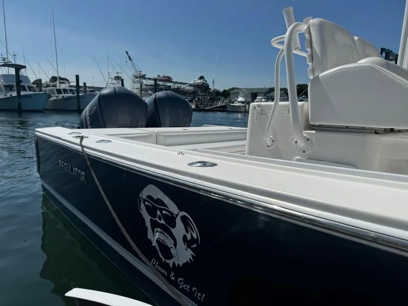 Slide: The Image of 2009 Regulator 32 Forward Seating boat docked in marina, featuring dual engines. - 7
