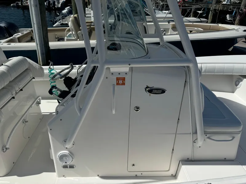 Slide: The Image of 2009 Regulator 32 Forward Seating boat interior with console and seating area. - 8
