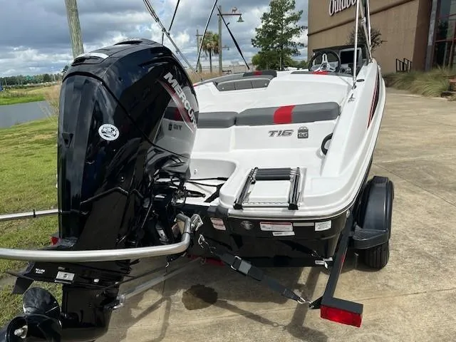 Slide: The Image of 2023 Tahoe T16 boat with Mercury outboard motor, parked outdoors. - 2