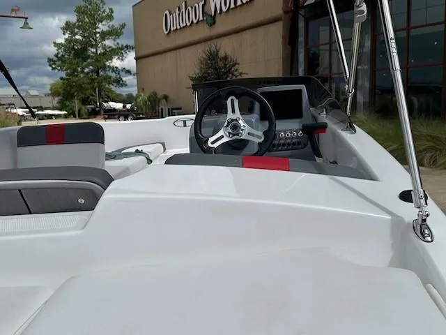 Slide: The Image of 2023 Tahoe T16 boat interior with steering wheel, near Outdoor World store. - 3