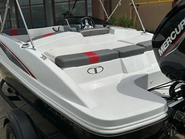 Slide: The Image of 2023 Tahoe T16 boat with Mercury engine, white and red seating, on trailer. - 4