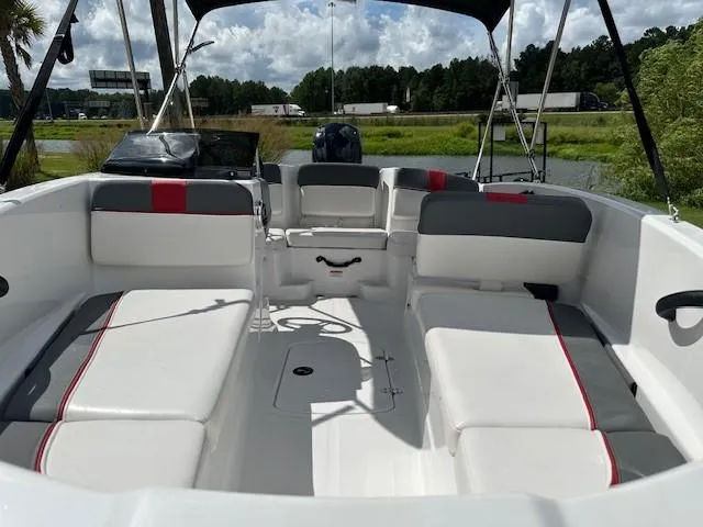 Slide: The Image of 2023 Tahoe T16 boat interior with white and gray seating, red accents, and open deck. - 5