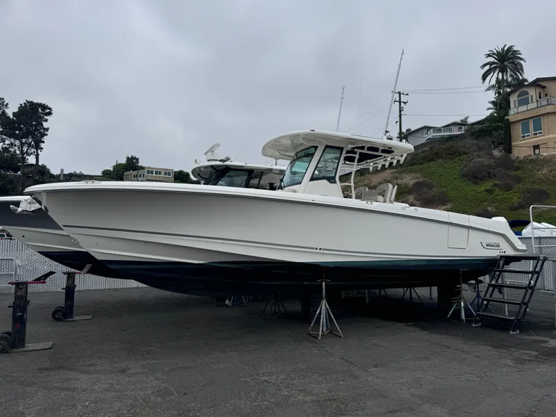 The Image of 2022 Boston Whaler 330 Outrage boat on stands, parked outdoors. - 0