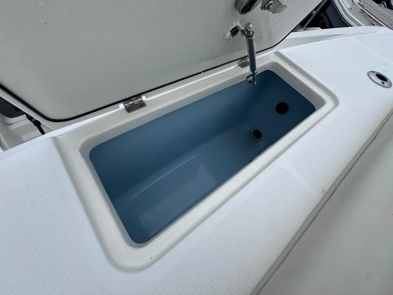 Slide: The Image of Boston Whaler 330 Outrage 2022, open storage compartment on deck. - 10