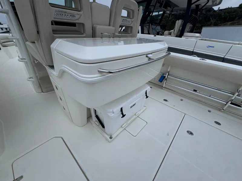 Slide: The Image of 2022 Boston Whaler 330 Outrage boat interior, featuring seating and storage area. - 13