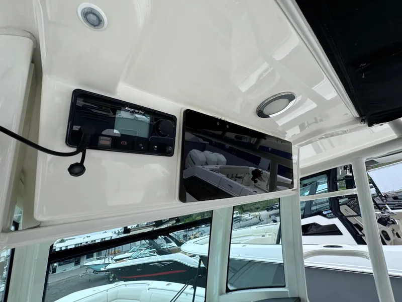 Slide: The Image of Interior view of 2022 Boston Whaler 330 Outrage boat with electronic controls. - 19