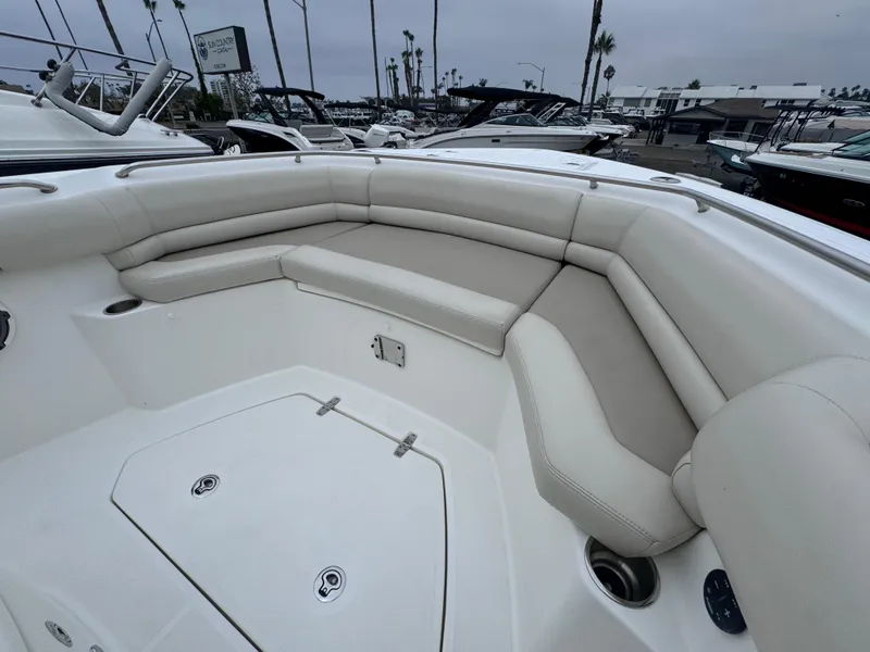 Slide: The Image of 2022 Boston Whaler 330 Outrage boat interior with cushioned seating and storage compartments. - 23
