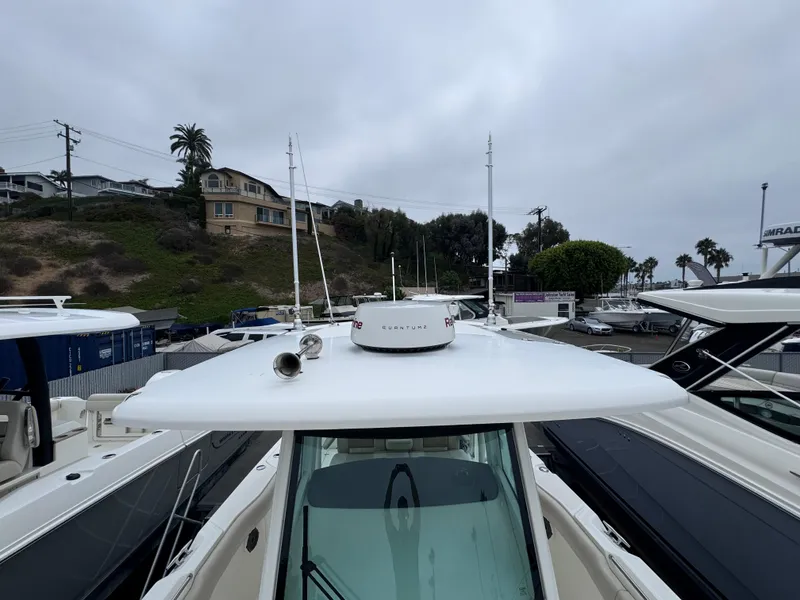 Slide: The Image of 2022 Boston Whaler 330 Outrage boat docked, showcasing sleek design and advanced features. - 25