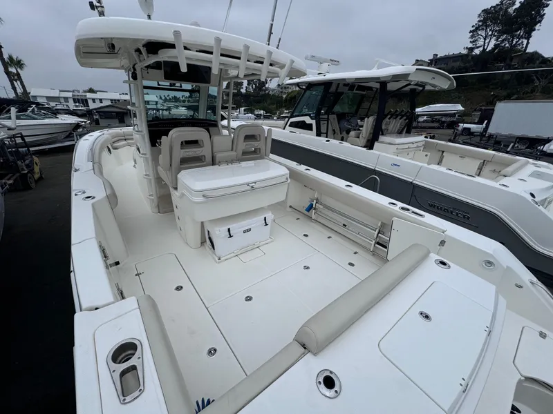 Slide: The Image of 2022 Boston Whaler 330 Outrage boat, spacious deck, modern design, docked at marina. - 6