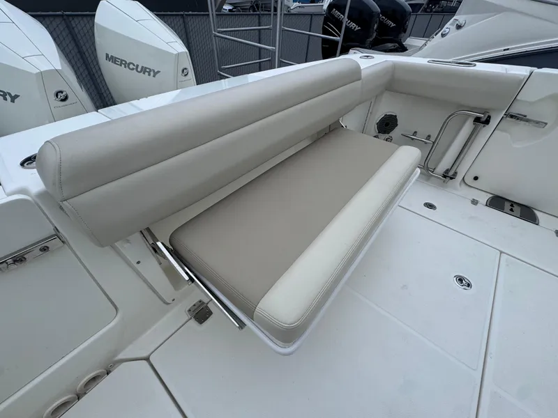 Slide: The Image of 2022 Boston Whaler 330 Outrage boat seating area with Mercury engines in the background. - 9