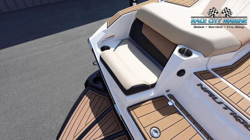Slide: The Image of 2022 Nautique Super Air Nautique G23 boat with tan seating and teak flooring. - 13