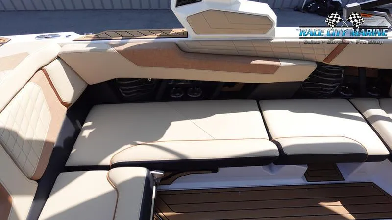 Slide: The Image of 2022 Nautique Super Air Nautique G23 interior seating with beige upholstery. - 21