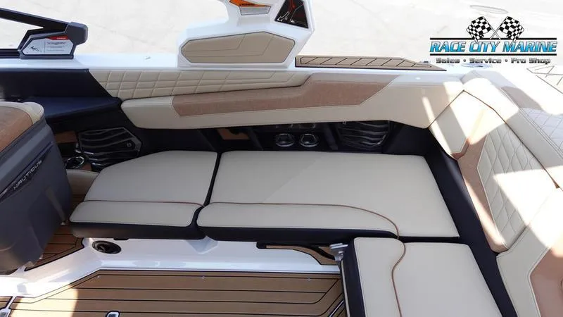 Slide: The Image of 2022 Nautique Super Air Nautique G23 interior seating with beige upholstery and sleek design. - 22