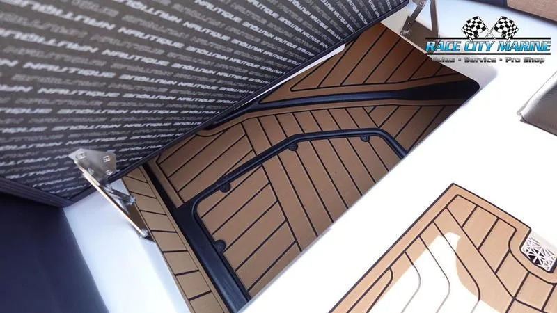 Slide: The Image of 2022 Nautique Super Air Nautique G23 interior flooring detail with Race City Marine branding. - 24