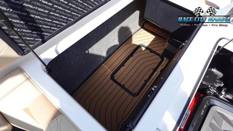 Slide: The Image of 2022 Nautique Super Air Nautique G23 storage compartment with teak flooring. - 25