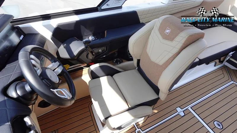 Slide: The Image of Interior of 2022 Nautique Super Air Nautique G23 boat with luxury seating and steering. - 27