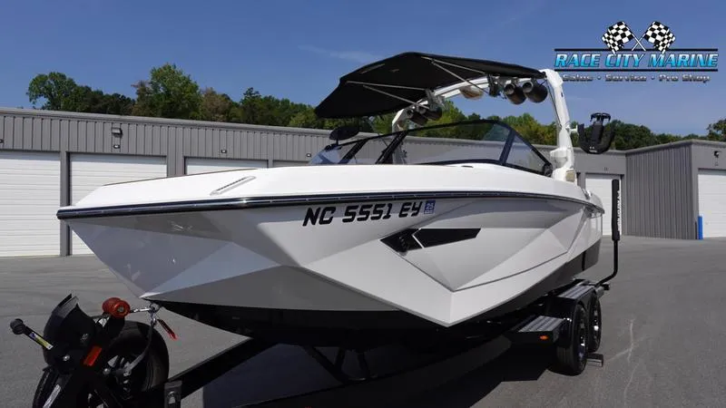 Slide: The Image of 2022 Nautique Super Air Nautique G23 boat on trailer, parked outside storage units. - 4