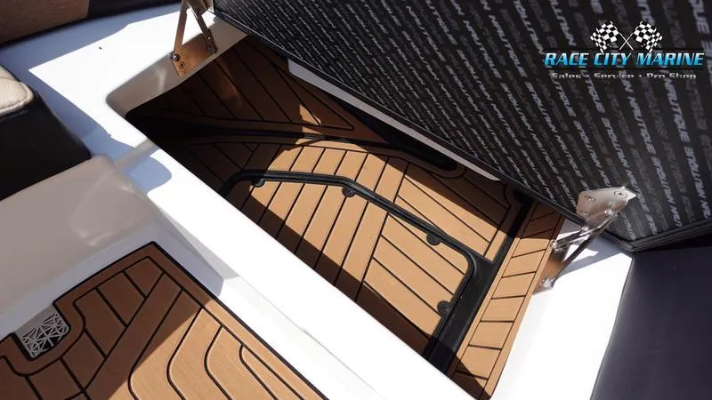 Slide: The Image of 2022 Nautique Super Air Nautique G23 storage compartment with teak flooring. - 41