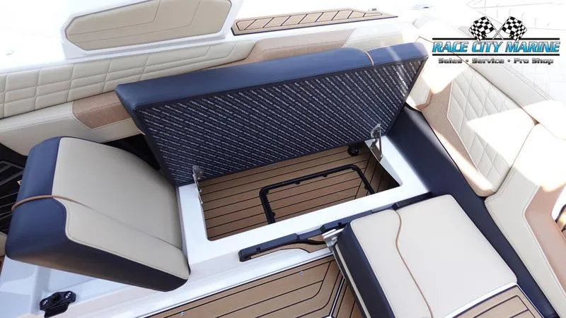 Slide: The Image of 2022 Nautique Super Air Nautique G23 interior seating with storage compartment open. - 43