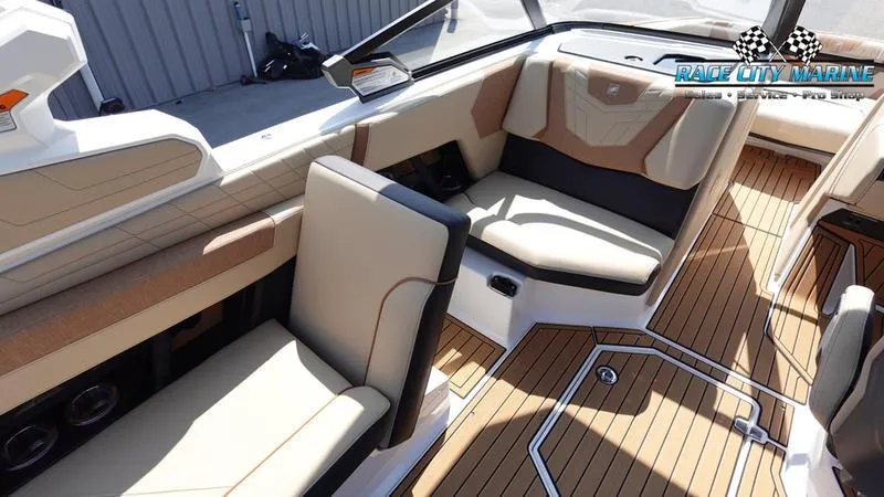 Slide: The Image of 2022 Nautique Super Air Nautique G23 interior with tan seating and teak flooring. - 46