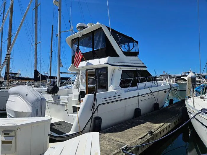 The Image of 1993 Navigator 4300 yacht docked at marina under clear blue sky. - 0