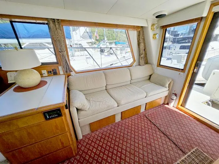 Slide: The Image of Cozy interior of a 1993 Navigator 4300 yacht with a beige sofa and wooden accents. - 11
