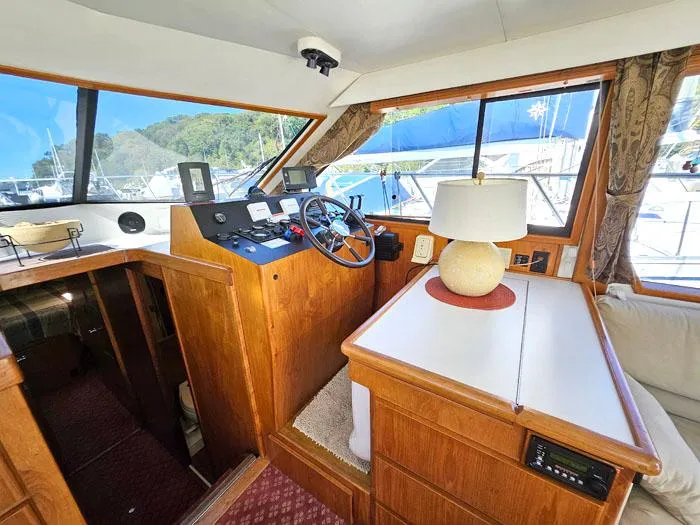 Slide: The Image of Interior of 1993 Navigator 4300 yacht with helm, wooden cabinetry, and lamp. - 12
