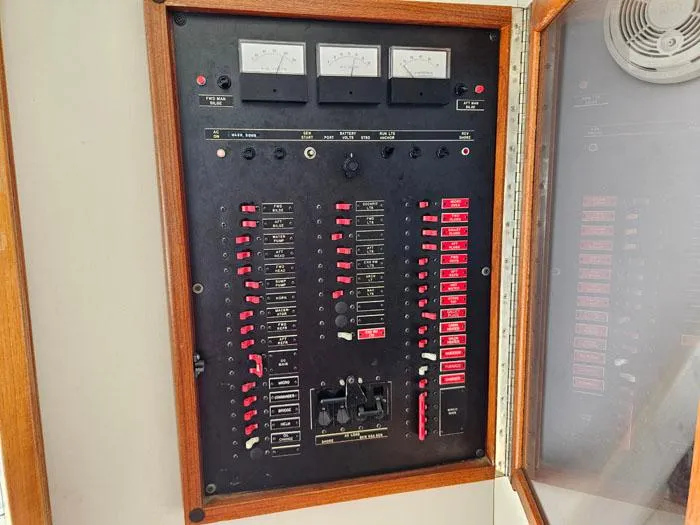 Slide: The Image of Electrical control panel on a 1993 Navigator 4300 boat, featuring switches and gauges. - 15