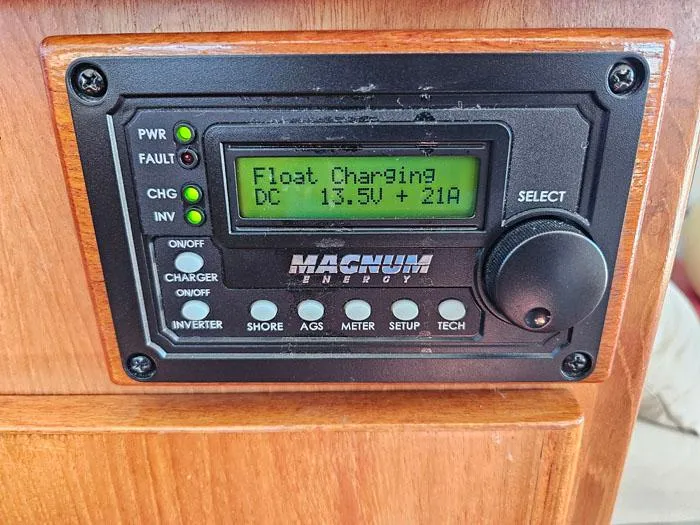 Slide: The Image of Control panel displaying "Float Charging" on a Magnum Energy device, Navigator 4300, 1993 model. - 16