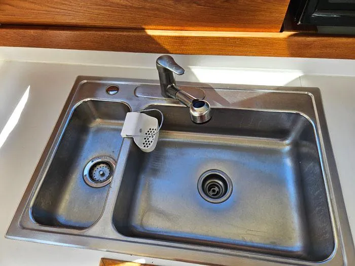 Slide: The Image of Stainless steel double sink with modern faucet in a 1993 Navigator 4300 boat. - 17