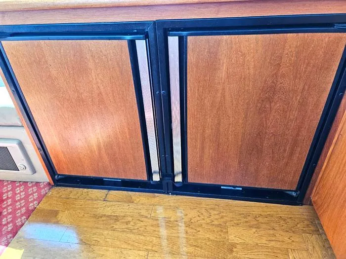Slide: The Image of Wooden cabinet doors on Navigator 4300, 1993 model, with black frames and carpeted floor. - 20