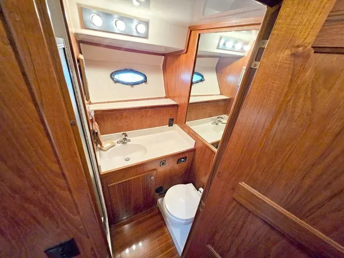 Slide: The Image of Bathroom interior of 1993 Navigator 4300 yacht with wood finish and porthole window. - 24
