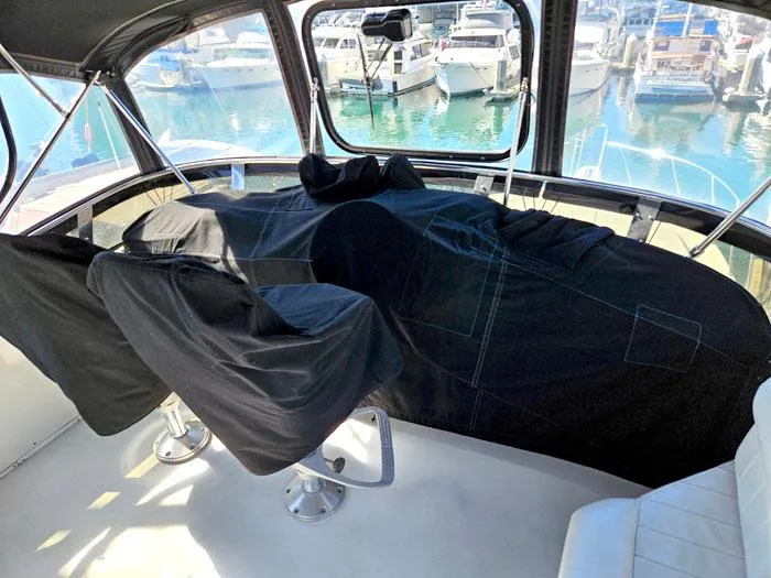 Slide: The Image of Covered cockpit of a 1993 Navigator 4300 yacht with marina view. - 35