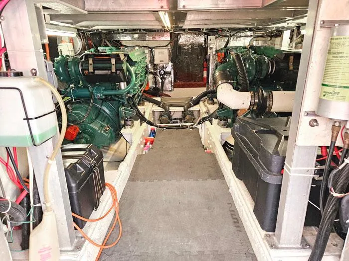 Slide: The Image of Engine room of a 1993 Navigator 4300 yacht, featuring dual engines and mechanical components. - 36