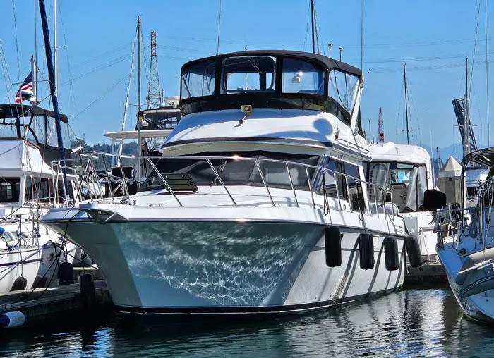 Slide: The Image of 1993 Navigator 4300 yacht docked in marina, surrounded by other boats, under clear blue sky. - 40