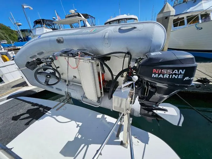 Slide: The Image of Inflatable boat with Nissan Marine outboard motor, docked at marina. - 5