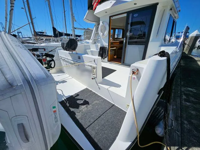 Slide: The Image of 1993 Navigator 4300 yacht docked, showcasing rear deck and open cabin entrance. - 6