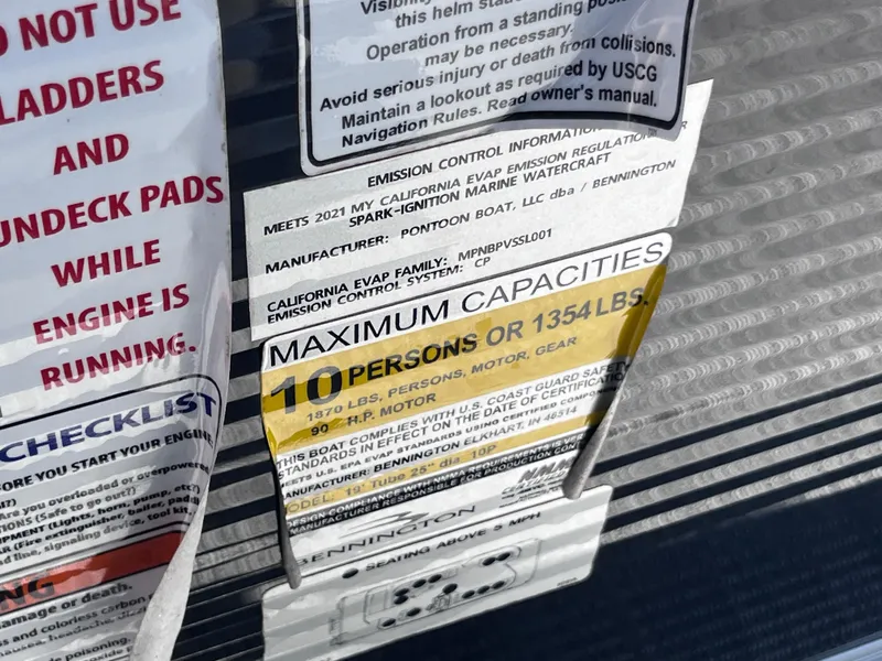 Slide: The Image of Capacity and safety labels on a 2021 Bennington SV 20 Quad Bench boat. - 11