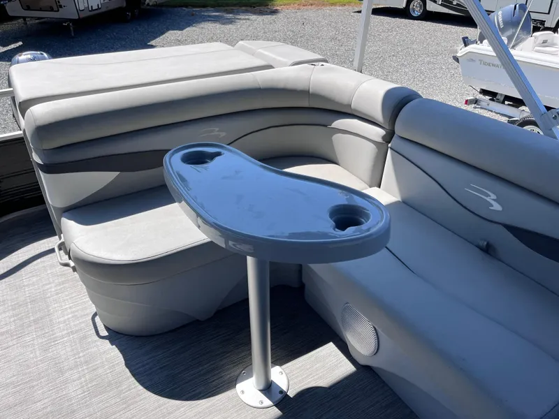 Slide: The Image of 2021 Bennington SV 20 Quad Bench interior with gray seating and table. - 15