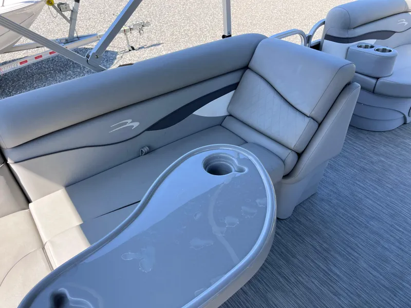 Slide: The Image of 2021 Bennington SV 20 Quad Bench with sleek gray seating and integrated cup holders. - 16