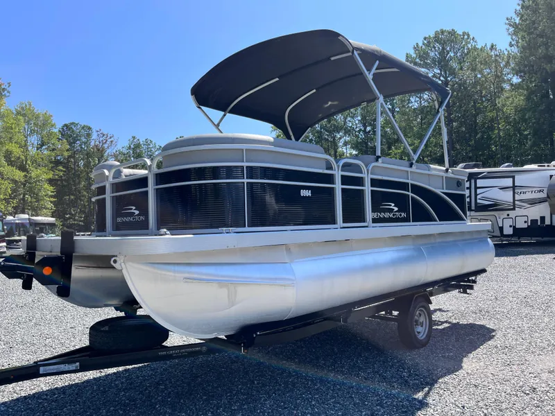 Slide: The Image of 2021 Bennington SV 20 Quad Bench pontoon boat on trailer, parked outdoors. - 4